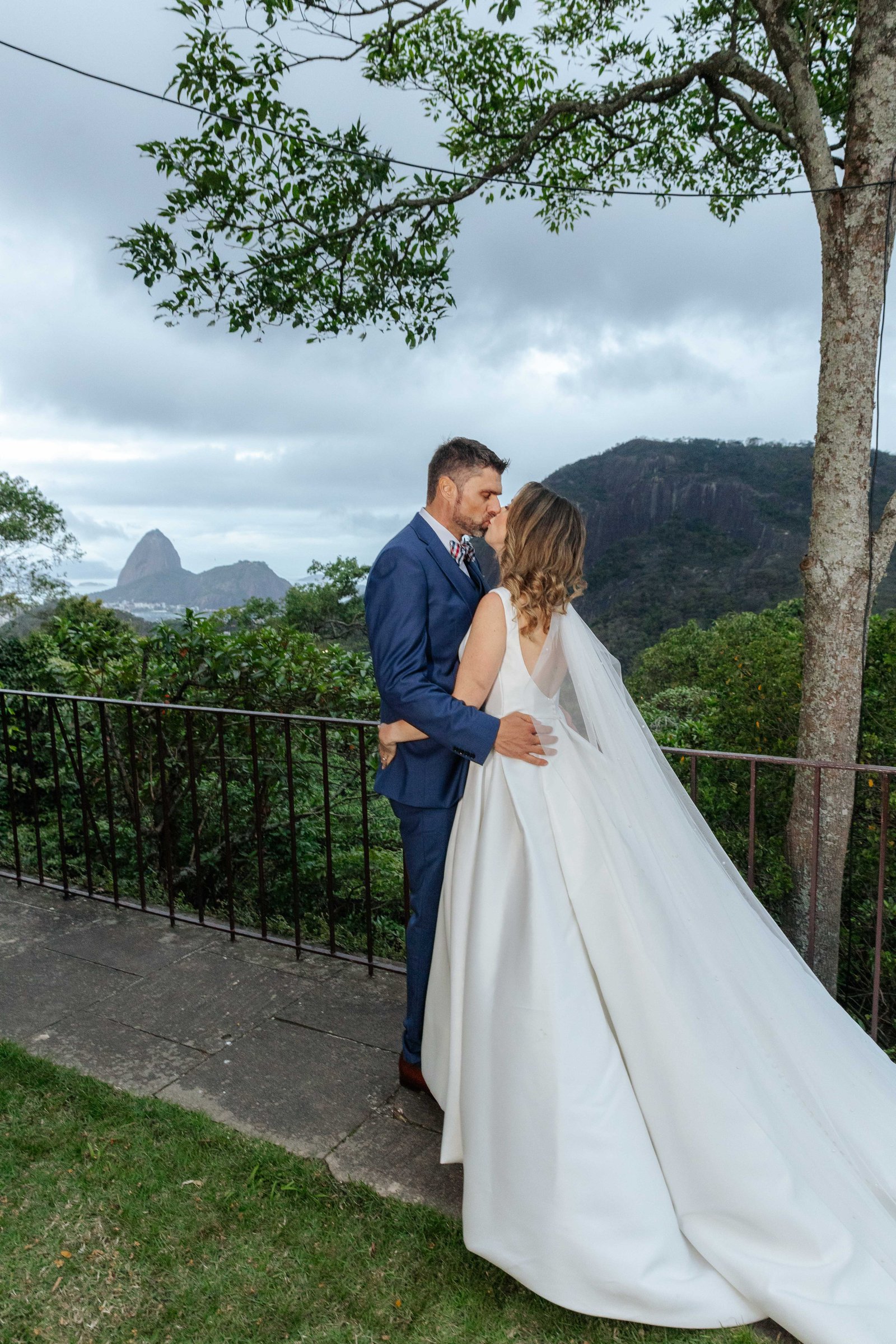 Couple kissing on terrace with Sugarloaf Mountain, Rio de Janeiro wedding