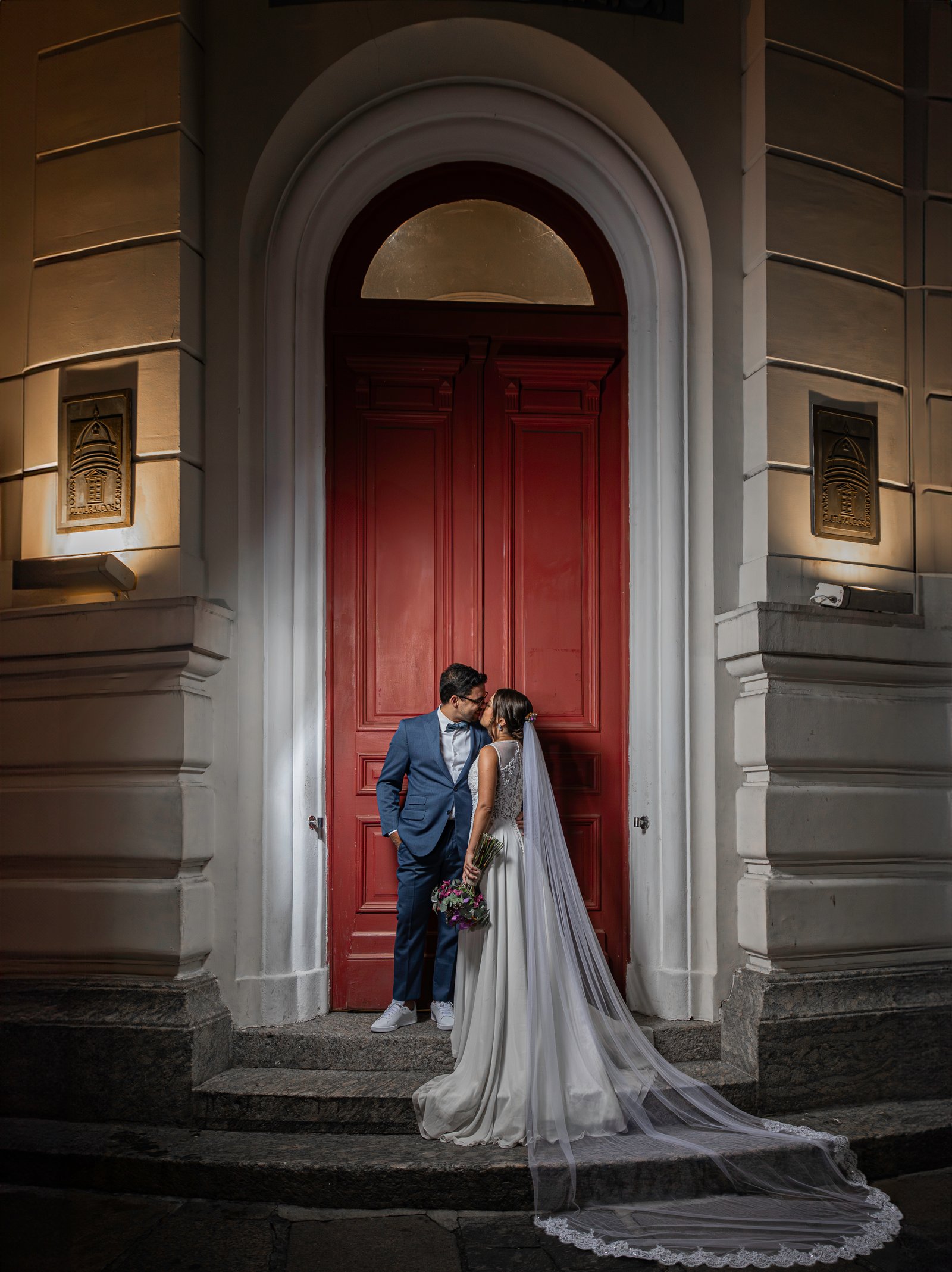 Couple kissing at historic red door at night, Rio de Janeiro wedding